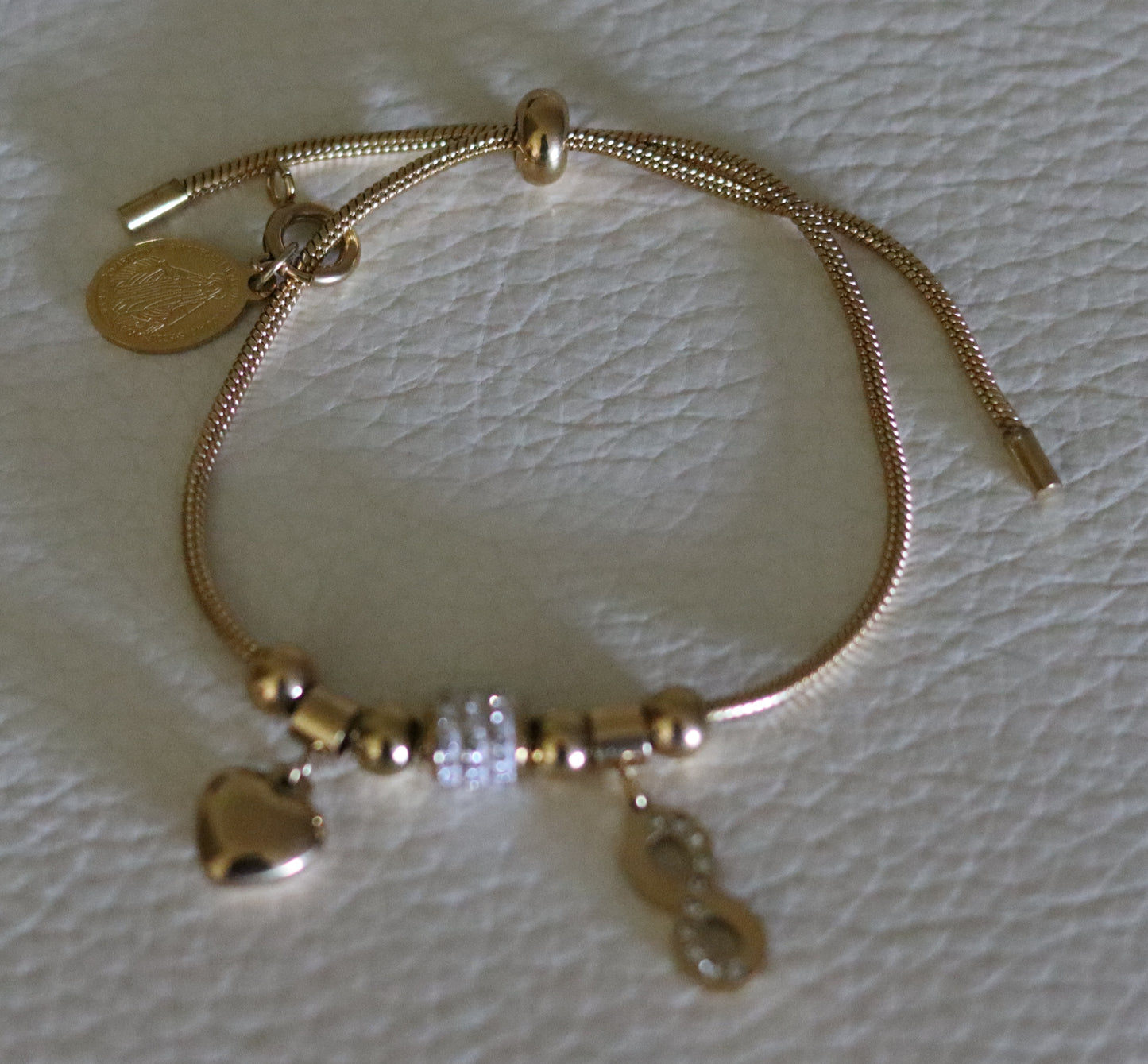 Bracelet lien coulissant motifs zircons, pampilles coeur et motif à l'infini avec médaille amovible Vierge Miraculeuse